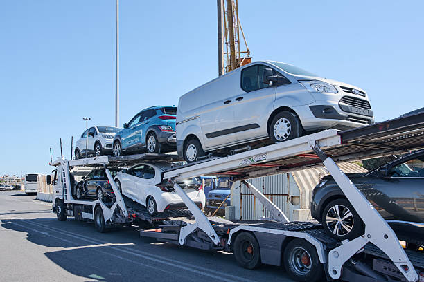 Crete.Greece - may 05, 2025: A multi-level vehicle transporter truck branded SAVALIS with cars securely positioned in two rows, demonstrating efficiency in logistics and automotive transportation.